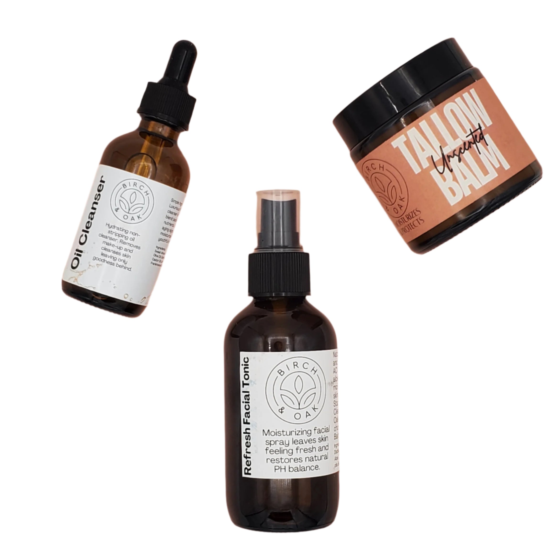 Three amber glass bottles with black and white labels, arranged on a neutral background. One bottle has a dropper, and the others have spray nozzles.