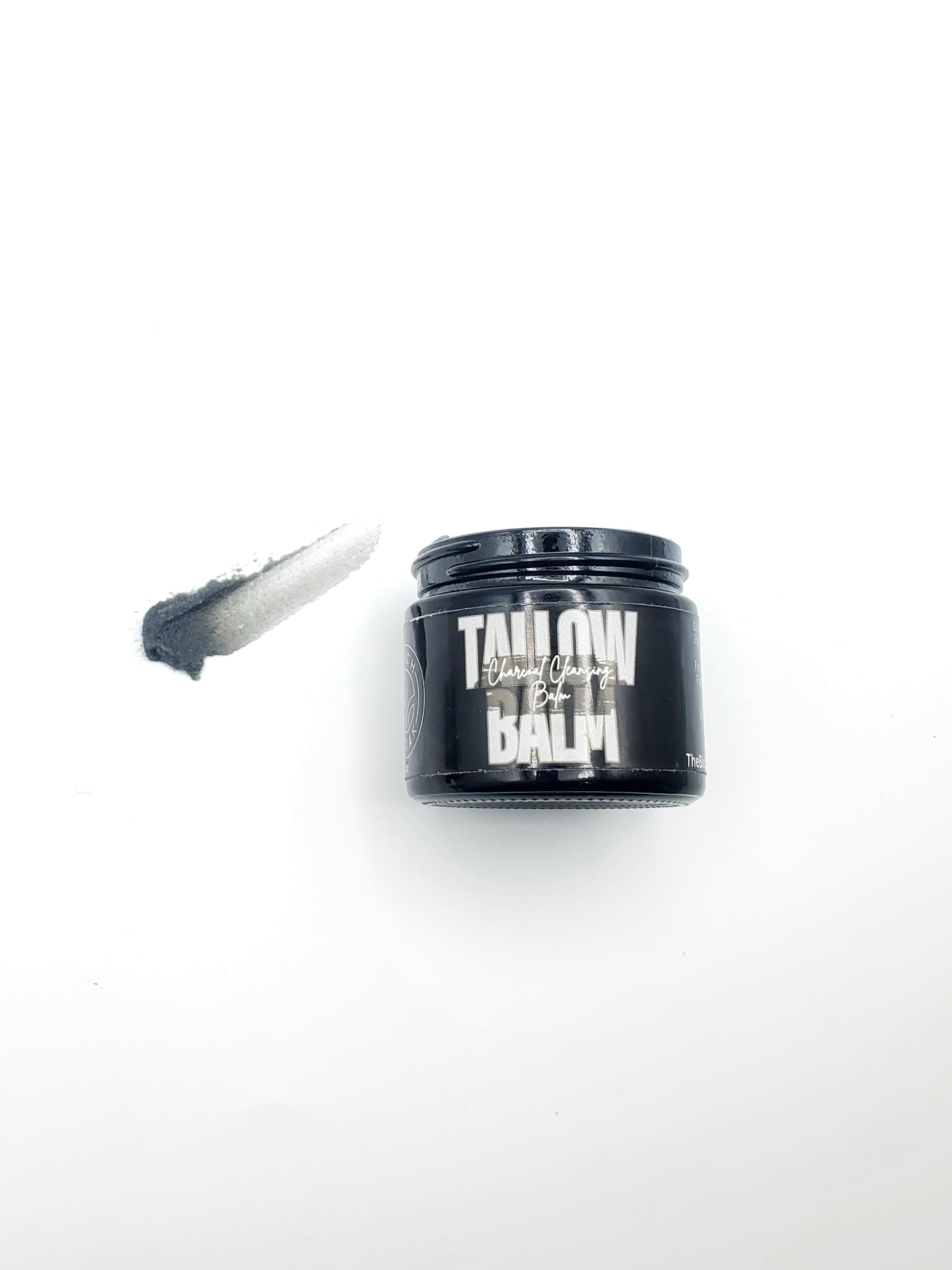 Tallow Balm container with applicator on a white background